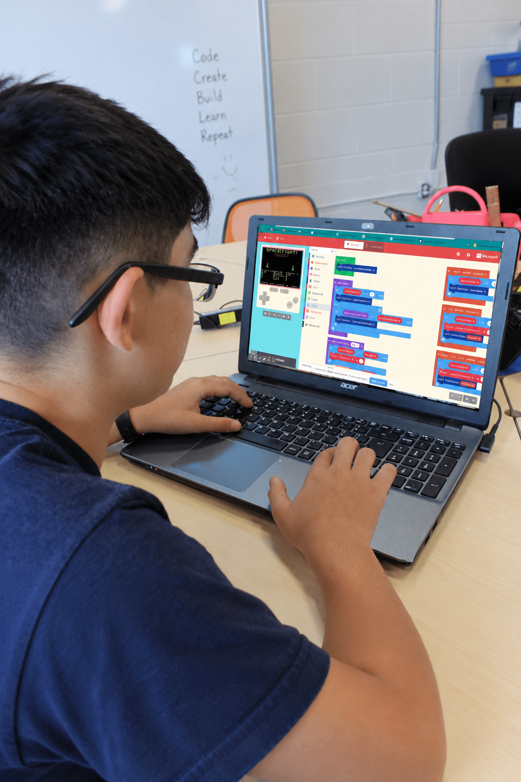 Student designing a game on a laptop